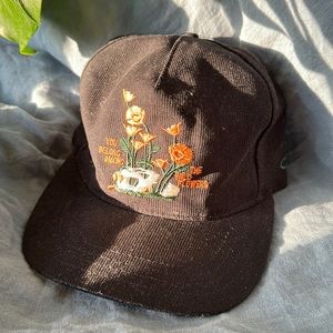 The Ampal Creative Black Corduroy Strapback Hat With Orange Wildflowers